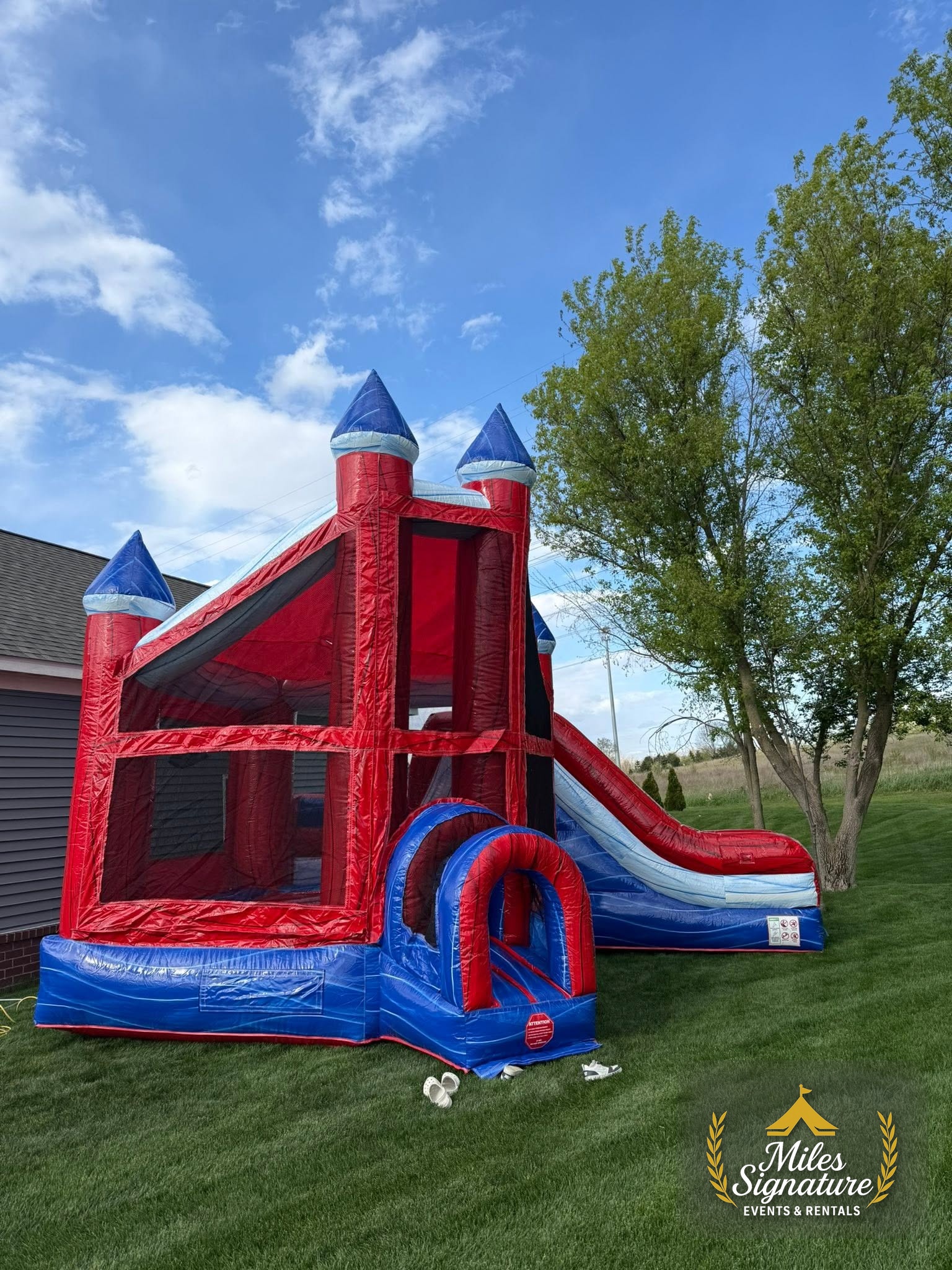 Red and blue bounce house set up on a lawn