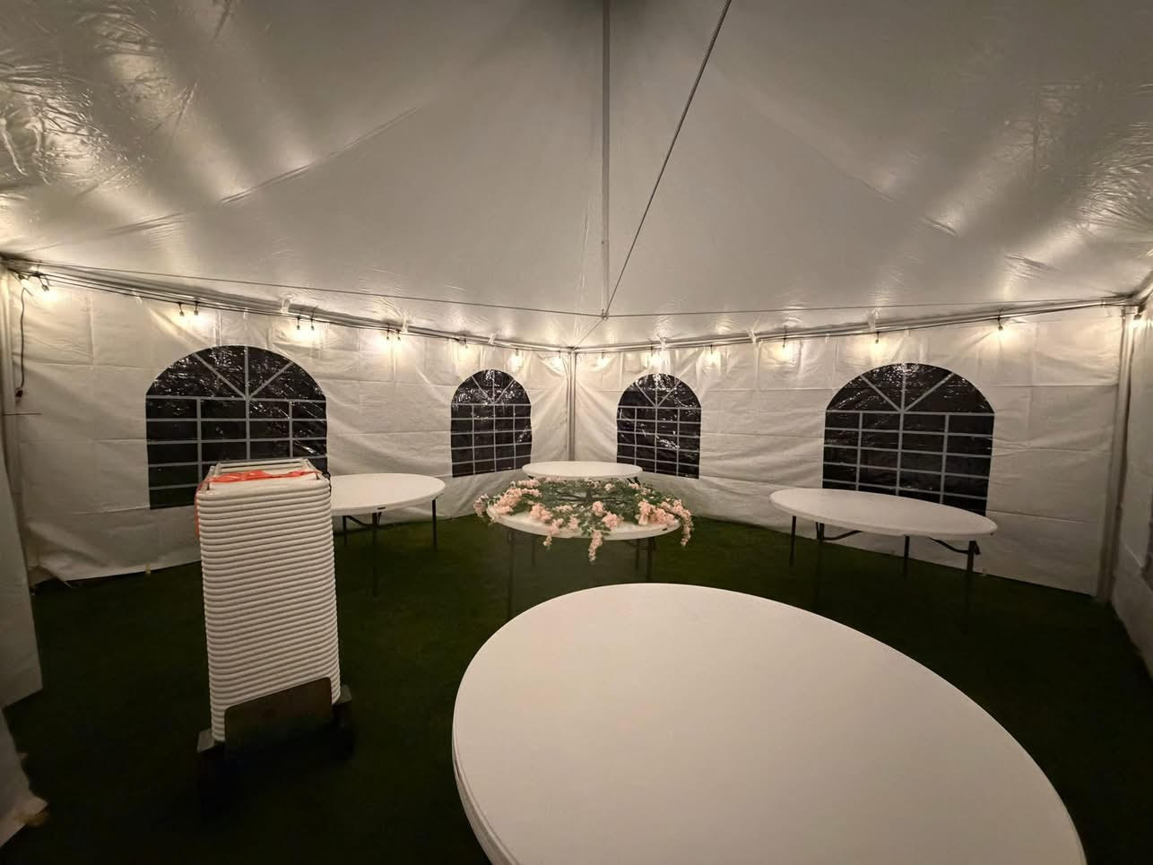 Tables arranged under a lit tent